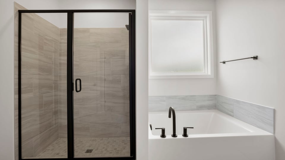 Bathroom with walk in shower and bathtub.