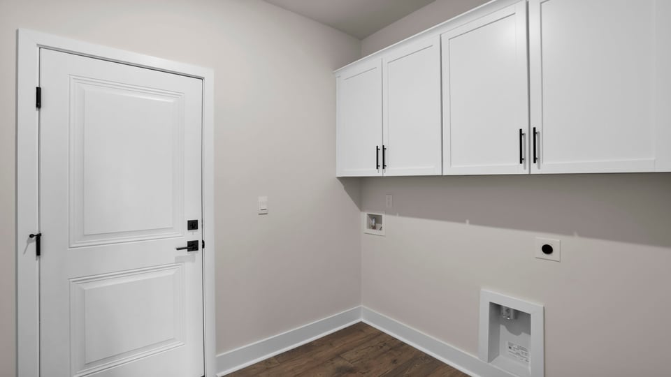Laundry room with cabinets.