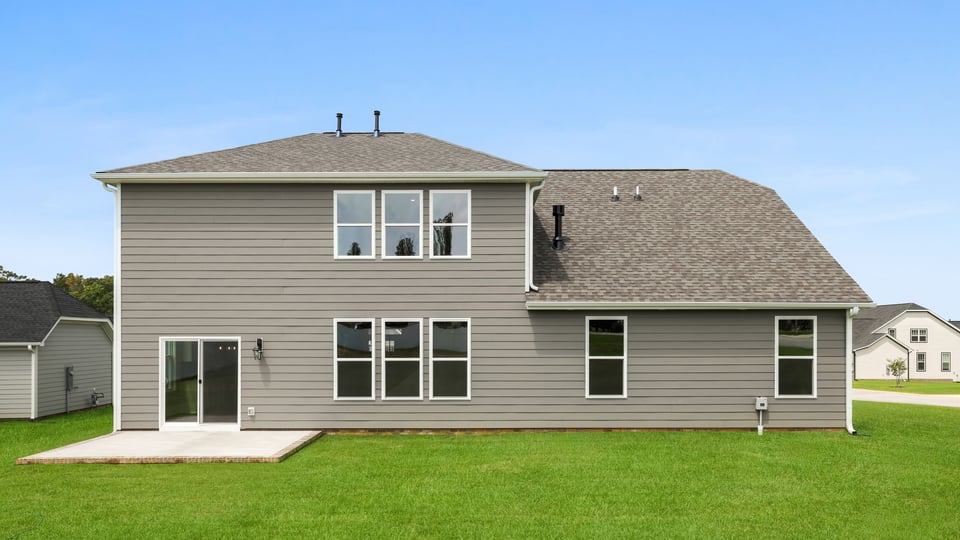 Back exterior of home with large backyard.