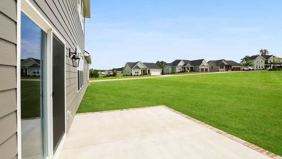 Back exterior of home with patio.