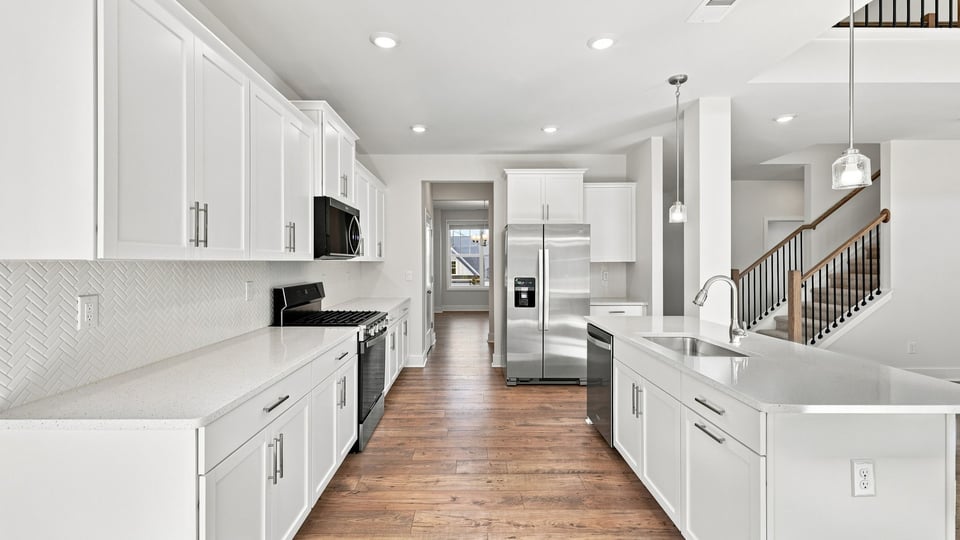 Kitchen and island with quartz countertops.