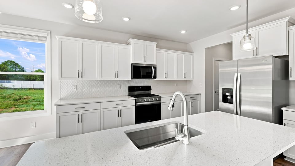 Kitchen and island with quartz countertops.