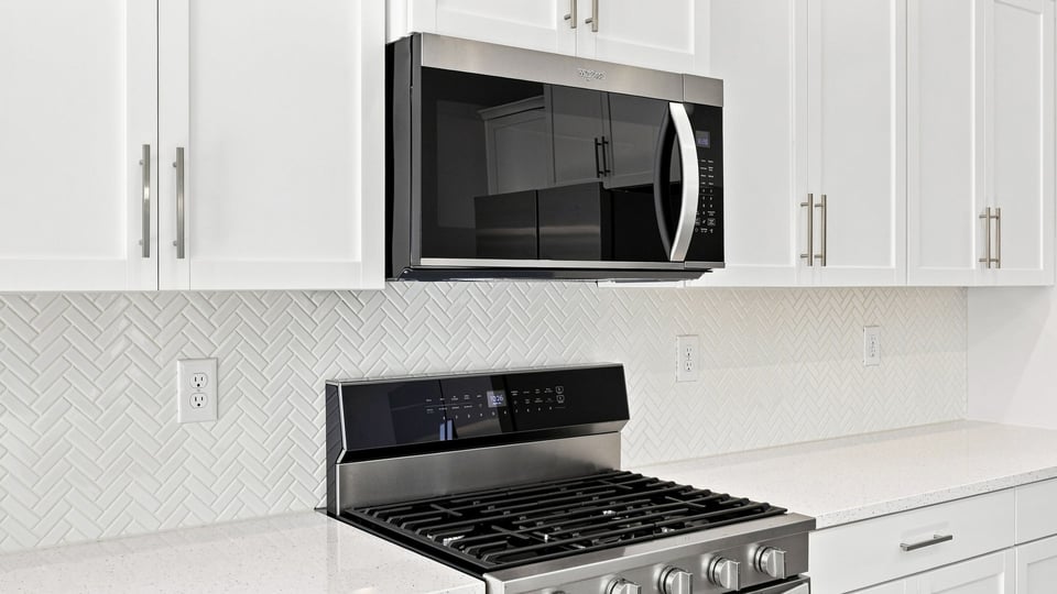 Kitchen and island with quartz countertops.