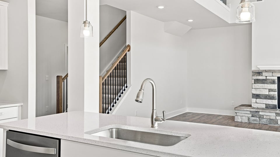 Kitchen and island with quartz countertops.