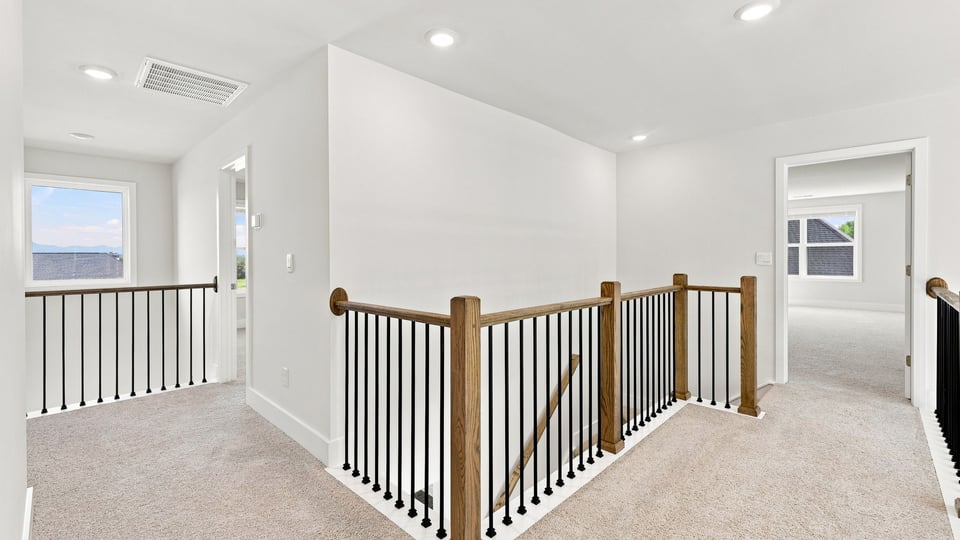 Hallway upstairs with carpet.