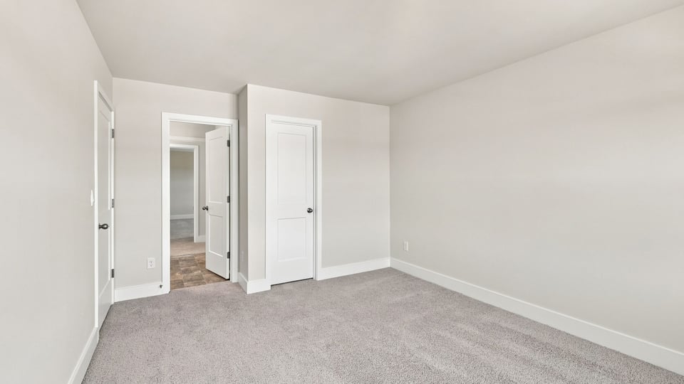 Bedroom with carpet and window.