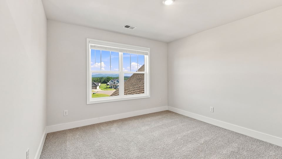 Bedroom with carpet and window.