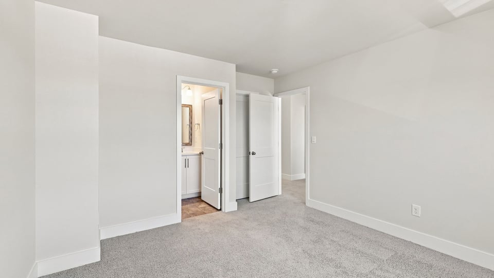 Bedroom with carpet and window.