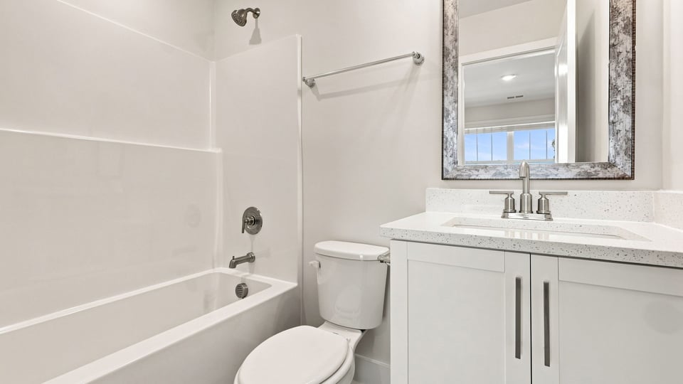 Bathroom with single vanity sink and bathtub.