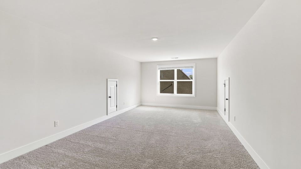Bedroom with carpet and window.