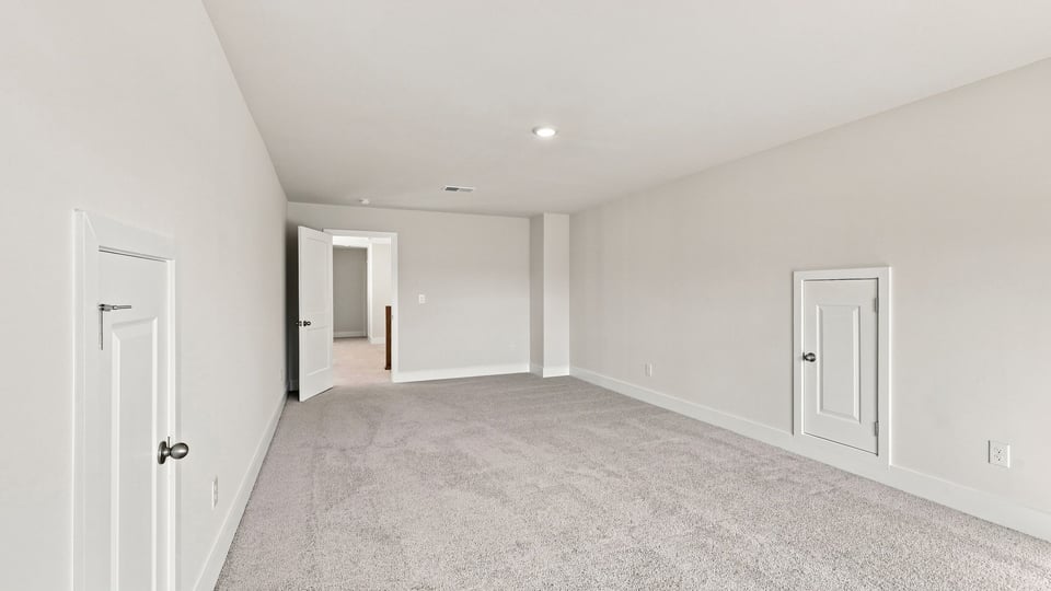 Bedroom with carpet and window.