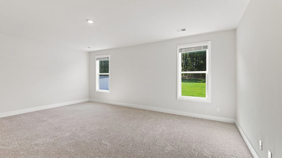 Bedroom with carpet and window.