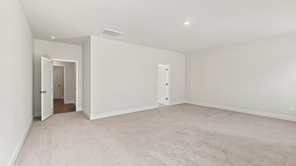 Bedroom with carpet and window.