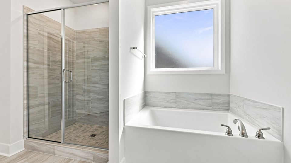 Bathroom with walk in shower and closet.