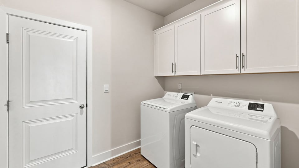 Laundry room with hanging cabinets.