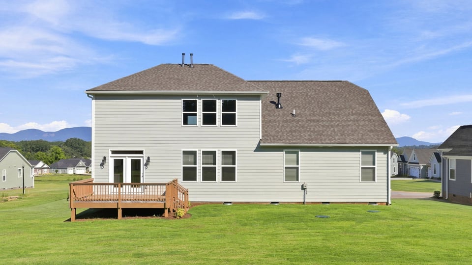 Back exterior of home with large backyard.