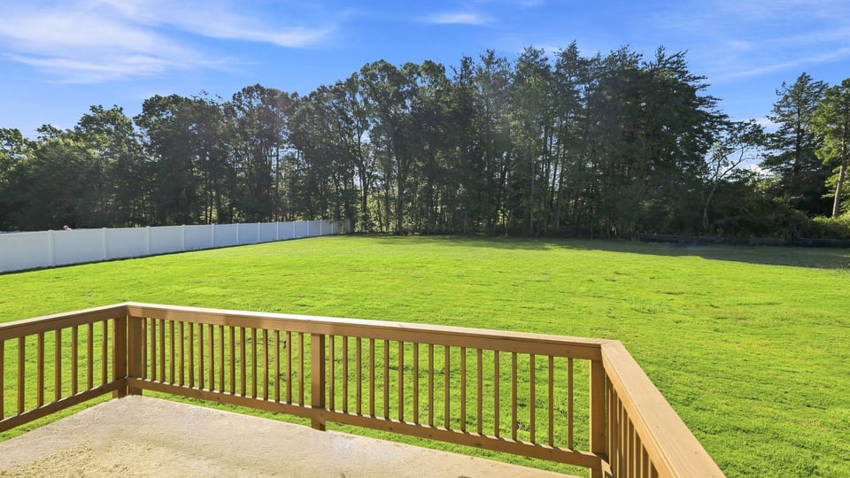 Back exterior of home with large backyard.