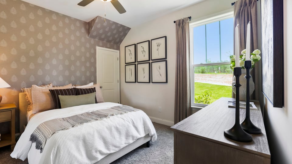 Bedroom with carpet and window.
