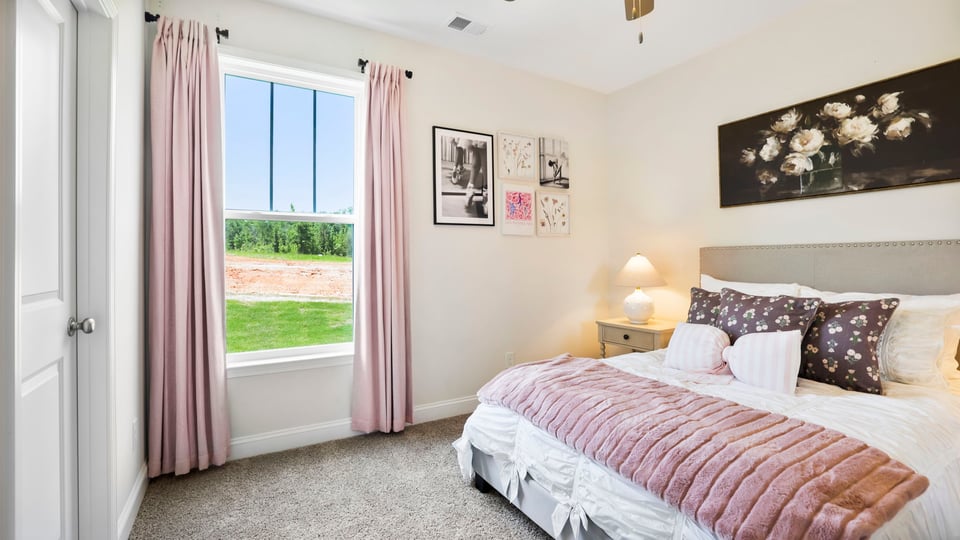 Bedroom with carpet and window.