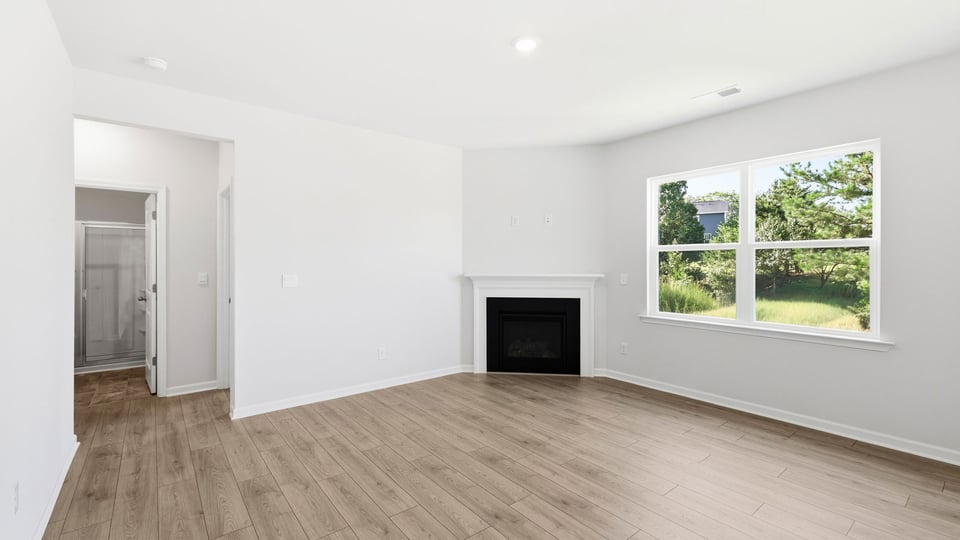 Living room with windows and fireplace.