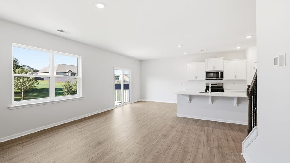 Living room with windows and fireplace.