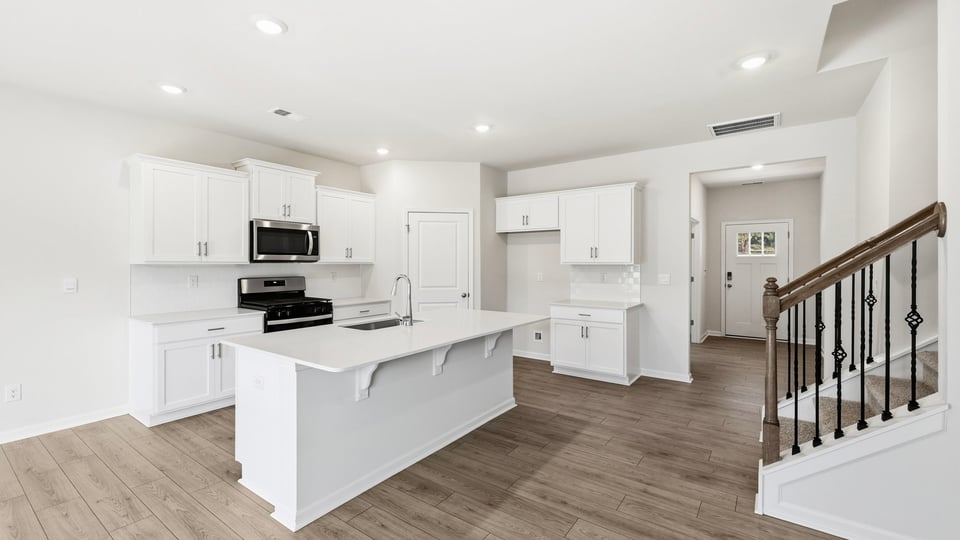 Kitchen and island with quartz countertops.