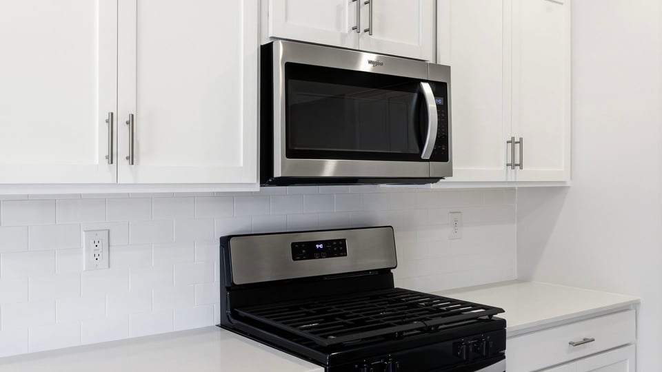 Kitchen and island with quartz countertops.