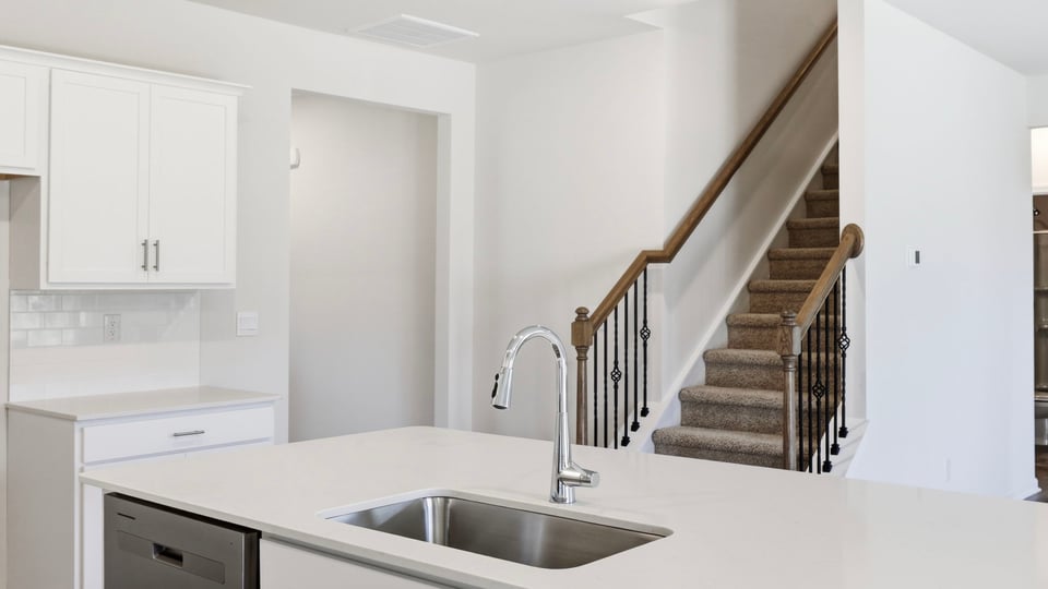 Kitchen and island with quartz countertops.