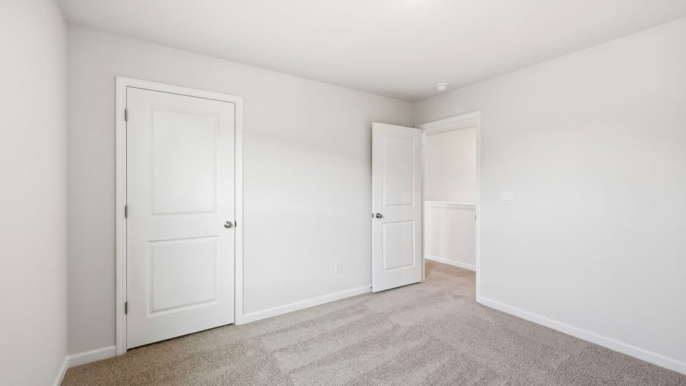 Bedroom with carpet and window.