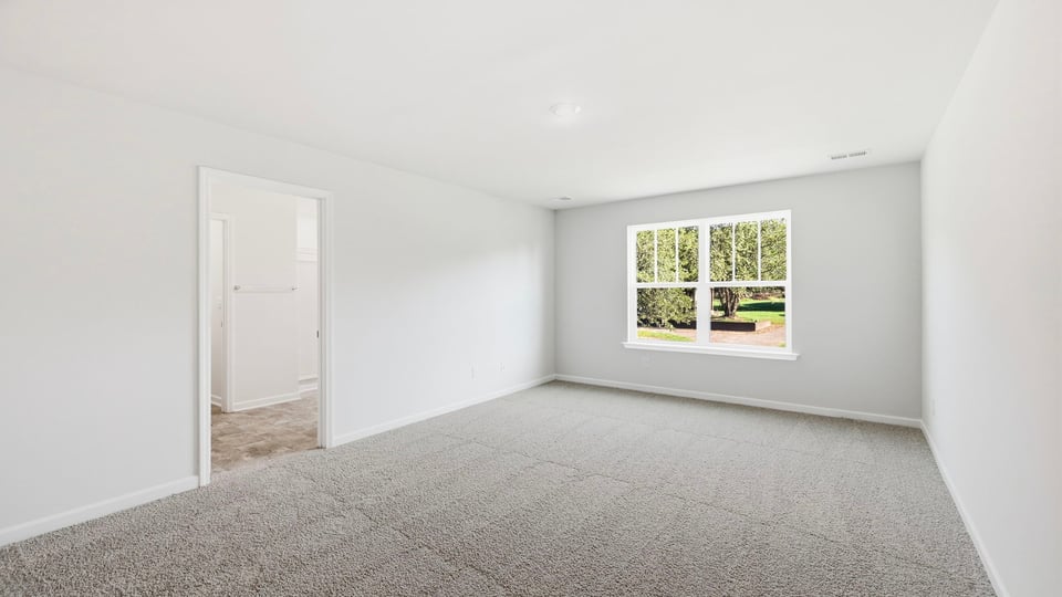 Bedroom with carpet and window.