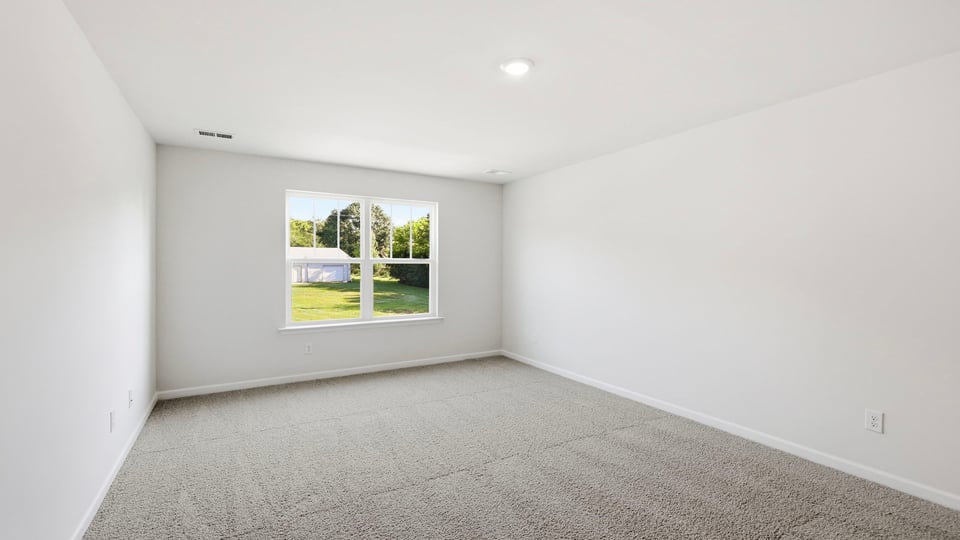 Bedroom with carpet and window.