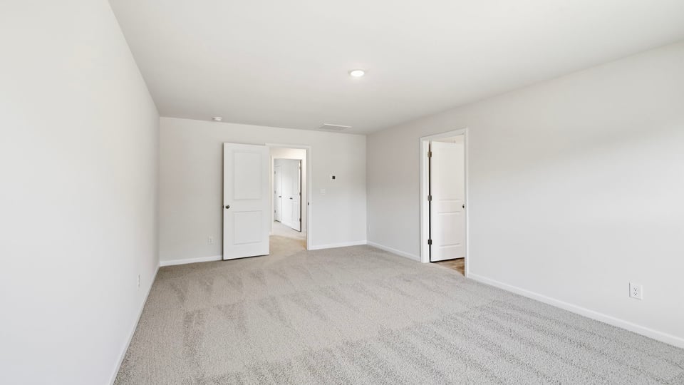 Bedroom with carpet and window.