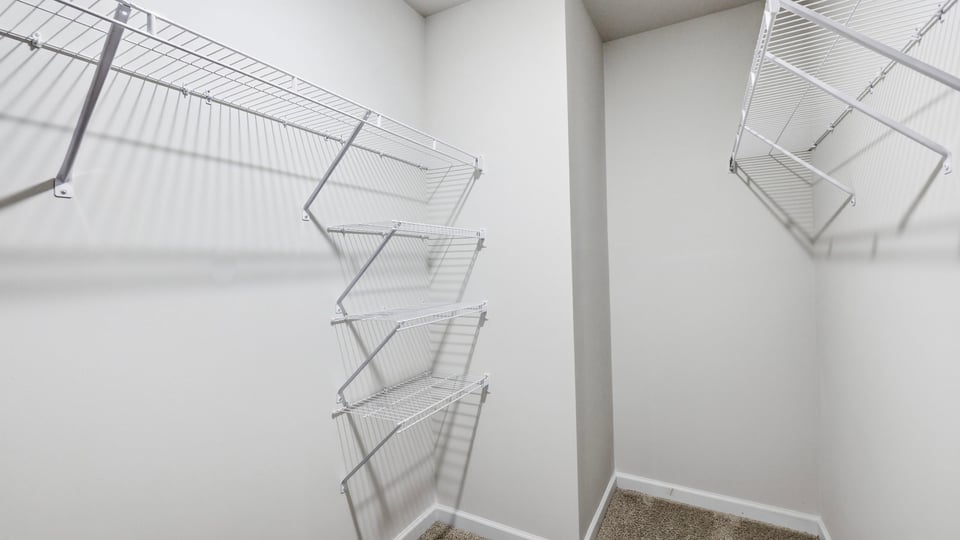 Closet with hanging storage racks.