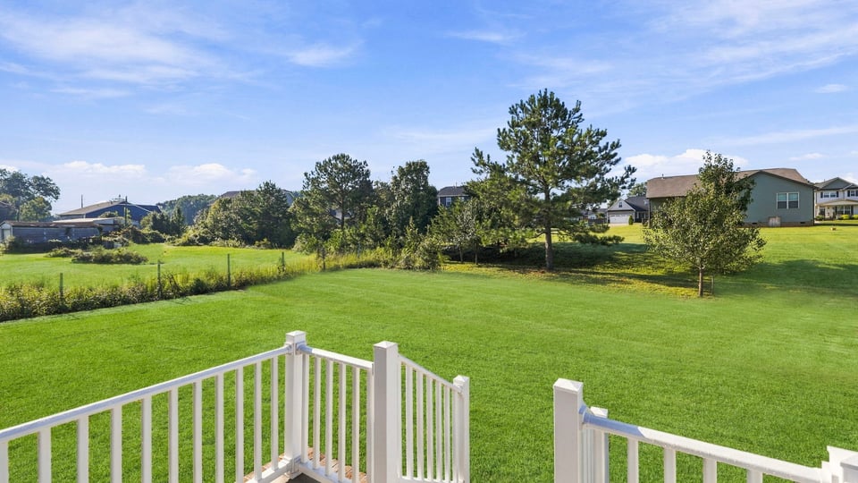 Back exterior of home with large backyard.