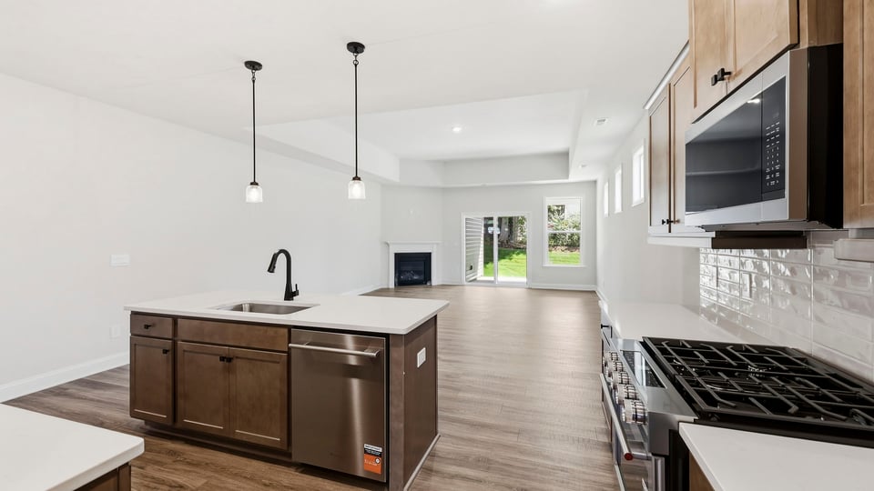 Kitchen and island with quartz countertops.
