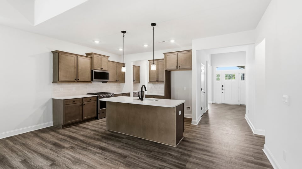 Kitchen and island with quartz countertops.