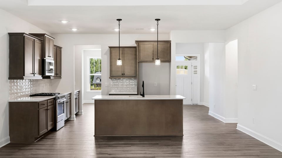 Kitchen and island with quartz countertops.