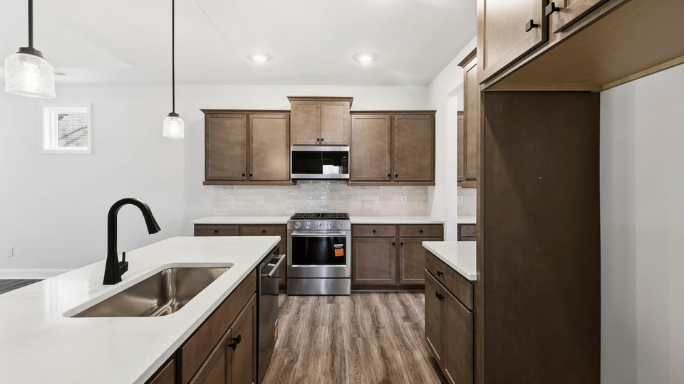 Kitchen and island with quartz countertops.