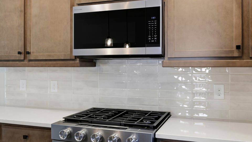 Kitchen and island with quartz countertops.