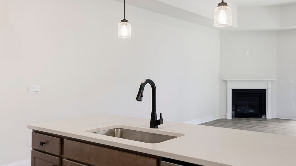 Kitchen and island with quartz countertops.