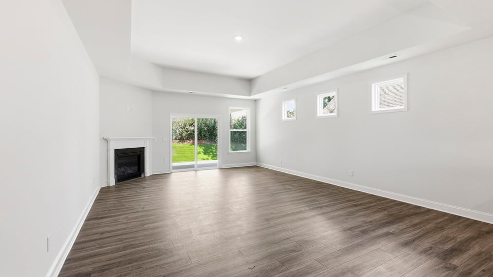 Living room with windows and fireplace.