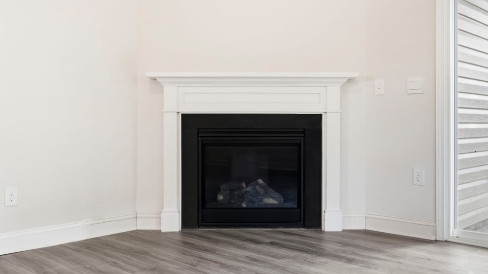 Living room with windows and fireplace.
