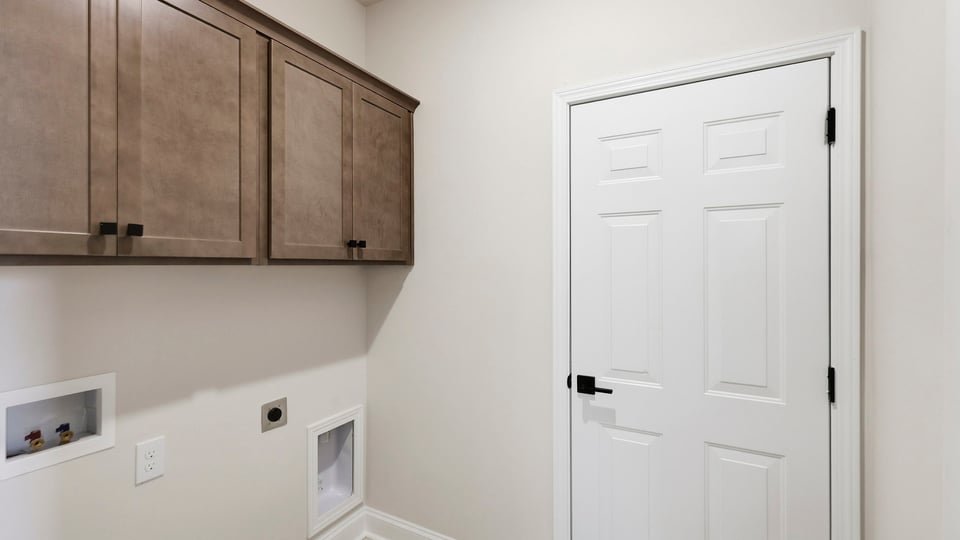 Laundry room with cabinets.