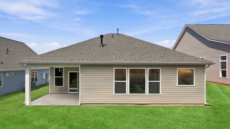 Back exterior of home with large backyard.