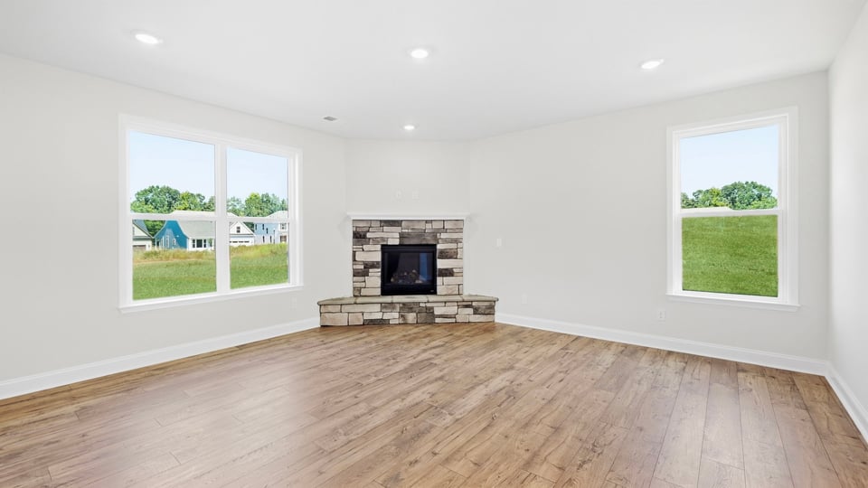Living room with fireplace and windows.