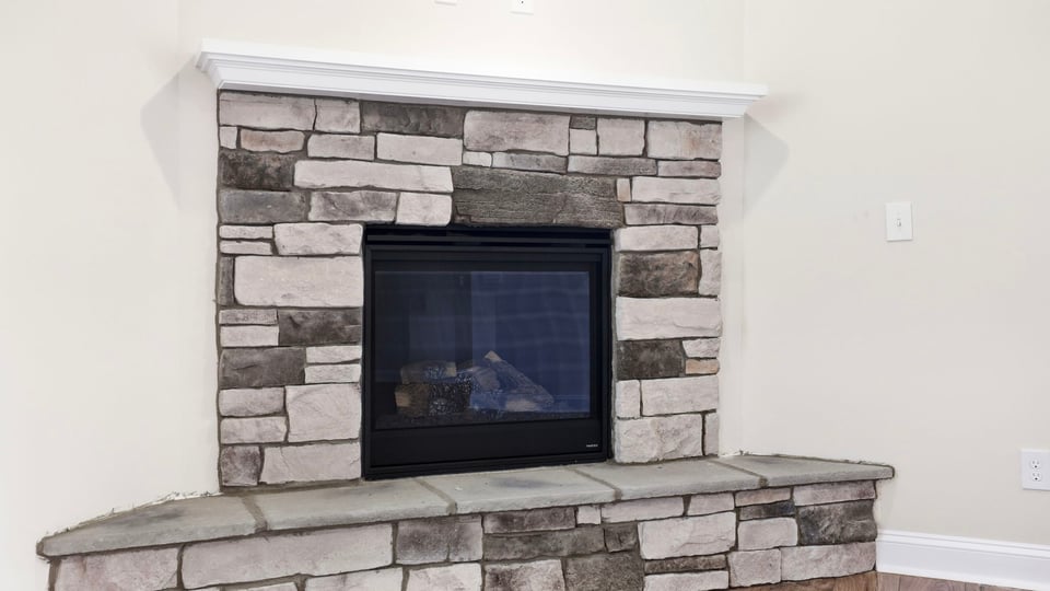 Living room with fireplace and windows.