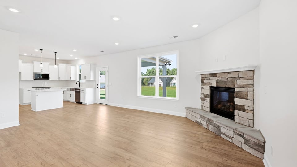 Living room with fireplace and windows.