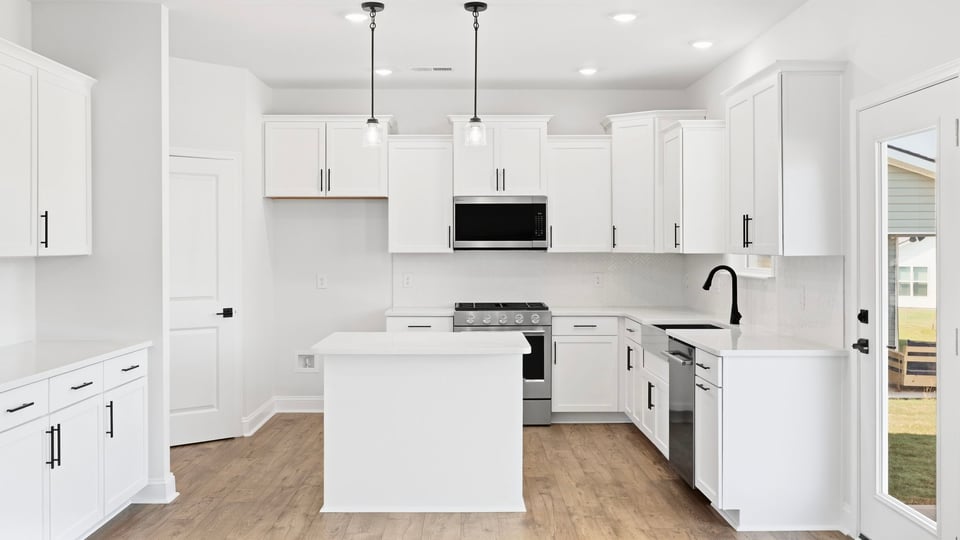 Kitchen and island with quartz countertops.