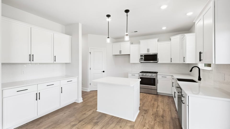 Kitchen and island with quartz countertops.