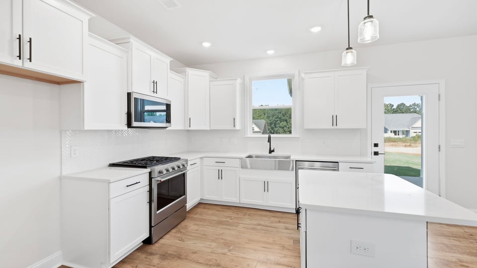 Kitchen and island with quartz countertops.